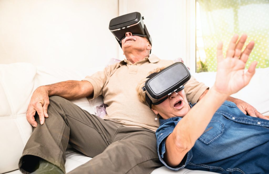Senior couple having fun together with virtual reality headset